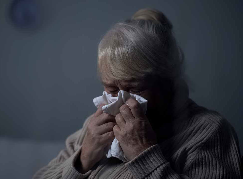 An elderly woman crying after enduring neglect and abuse in her nursing home in Philadelphia